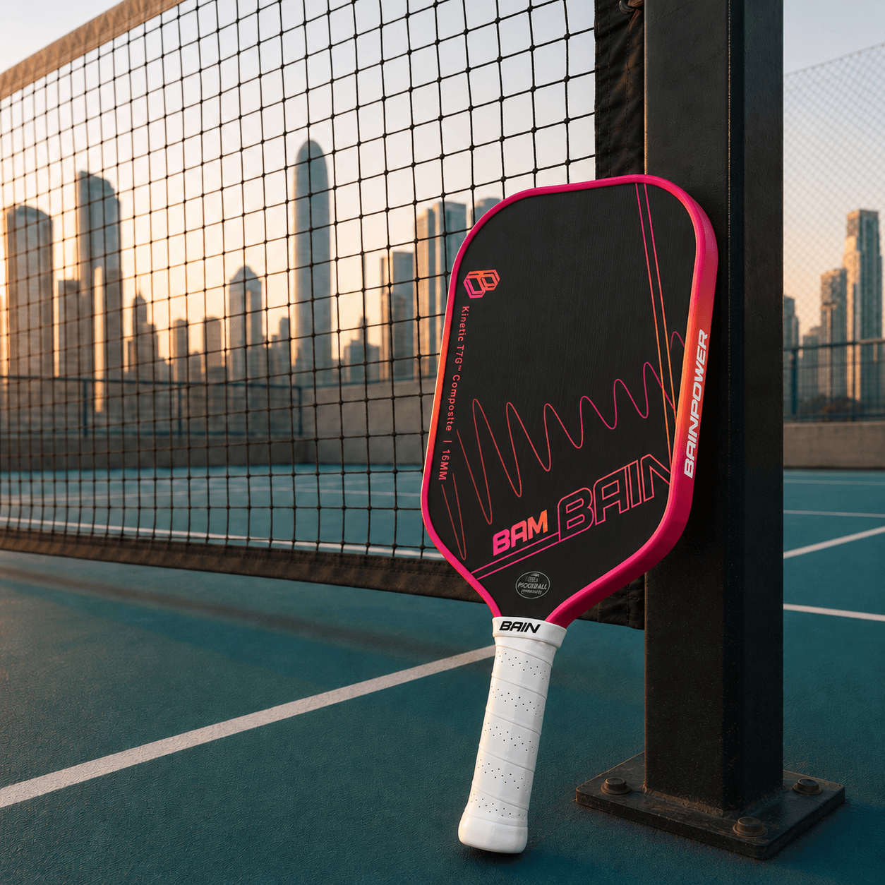 BAM paddle leaning on a court net post, Hong Kong skyline behind